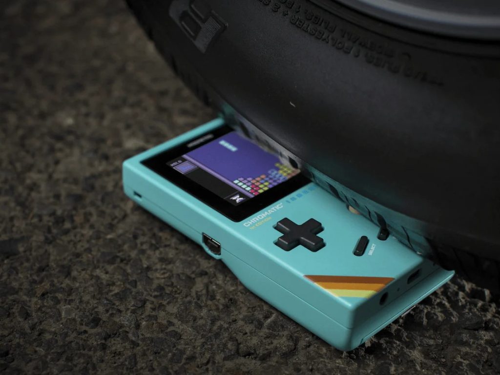 Chromatic by ModRetro under a vehicle tire showing it's durable