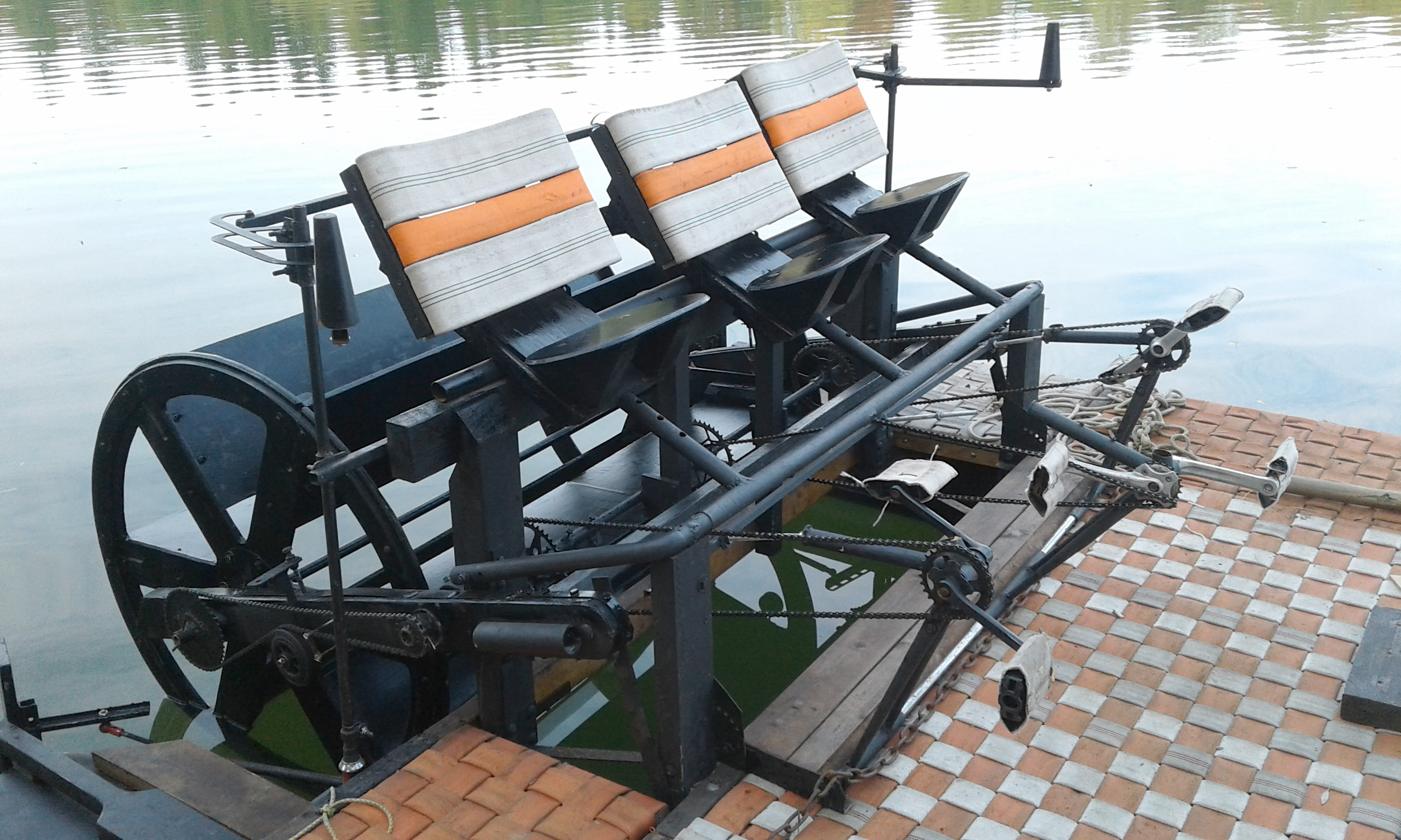 Kinobox Obscura boat floating in water. Waterwheel mechanics and driver seat design and building were my field of responsibility in the project.