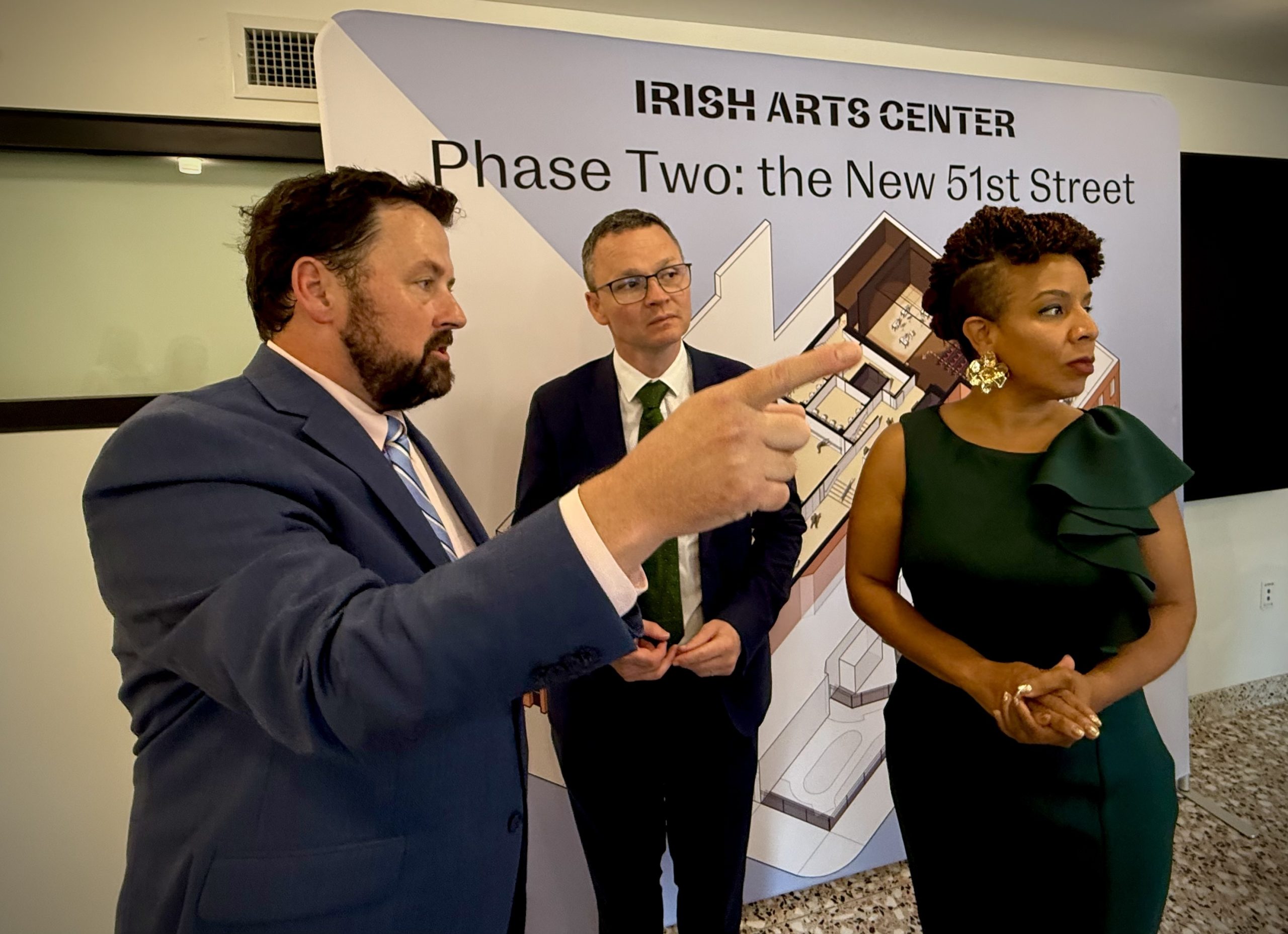 Man being interviewed in front of Irish Arts Center banner