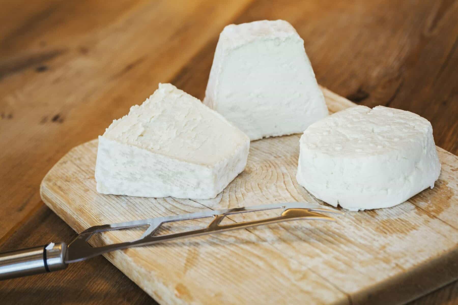 Close up of fresh goats cheese. The overall mood should be inviting, cozy, and wholesome, typical of a rustic kitchen. Lightbox photo taken with nikon d750 ar 16:9 --v 6. 0