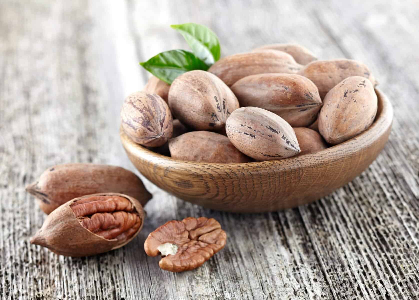 Pecan nuts on wooden background
