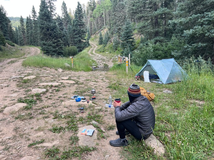 campsite along a forest road next to a creek on the santa fe to taos thru hike