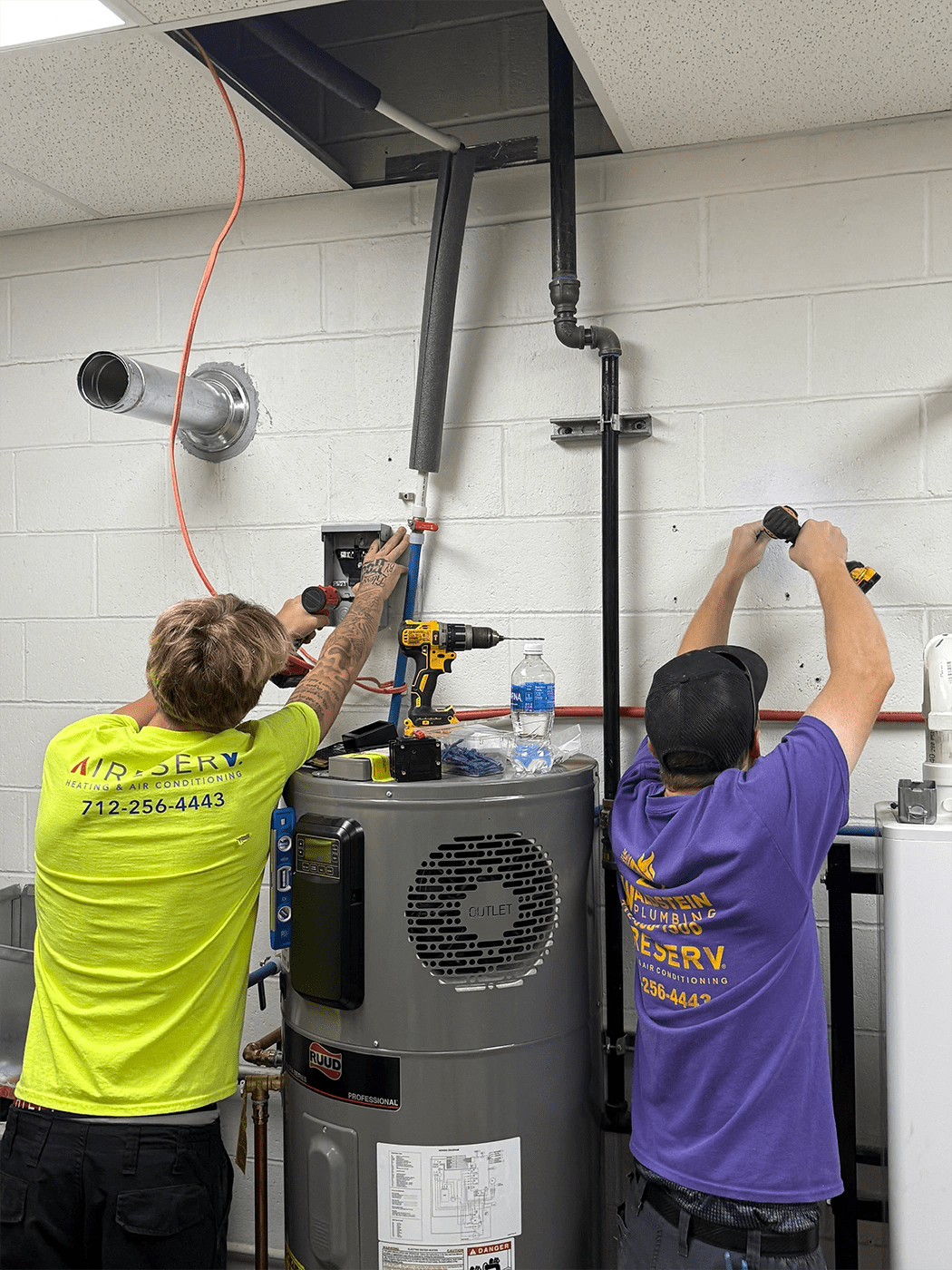 Two men working on a water heater