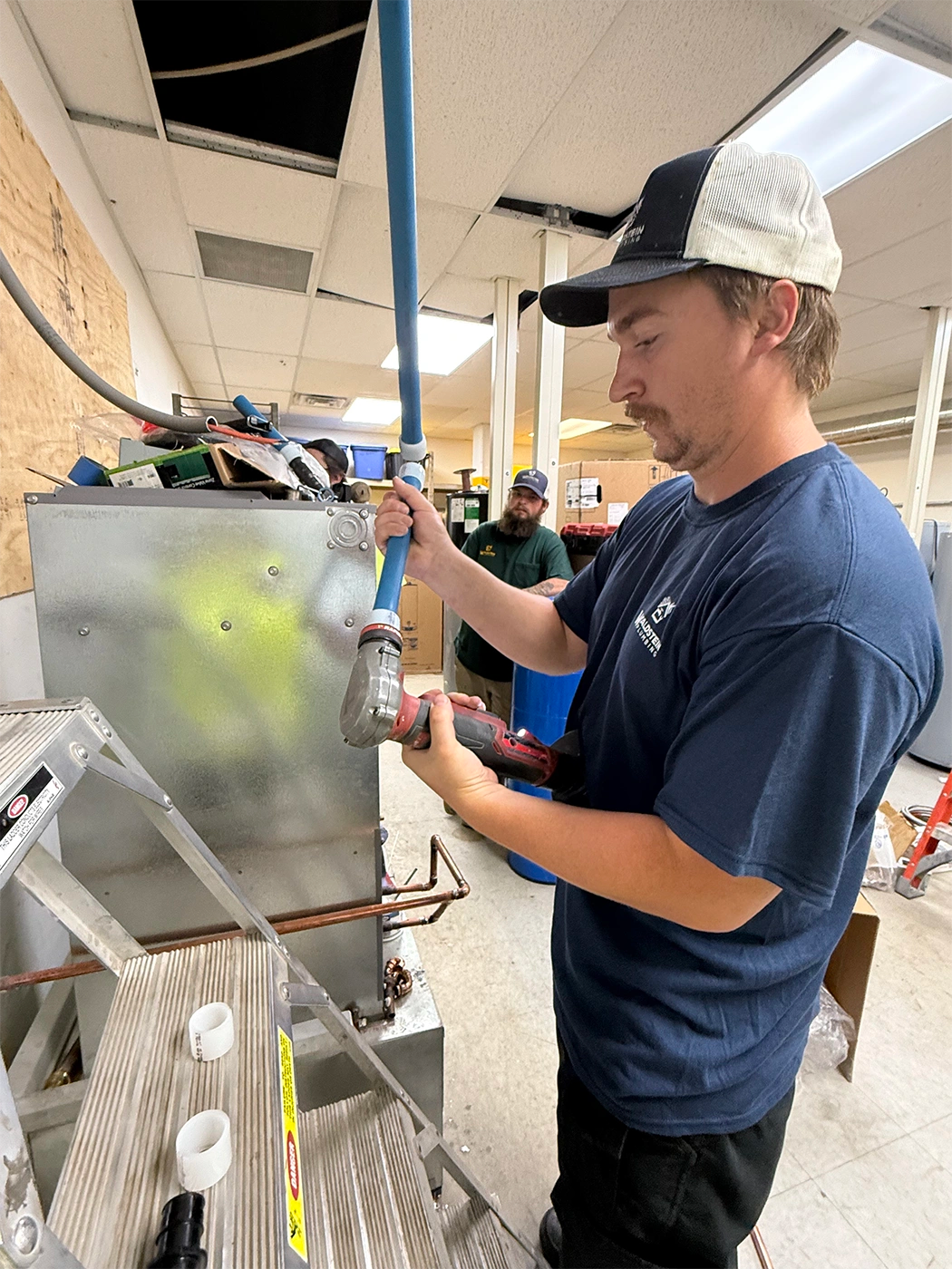 Man holding a tool and piping
