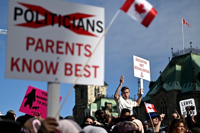 A photo of protesters demonstrating against sexual orientation and gender identity programs in schools on Parliament Hill in Ottawa on September 2023.