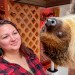 Woman and a sloth at Little Ray's Nature Center in Syracuse