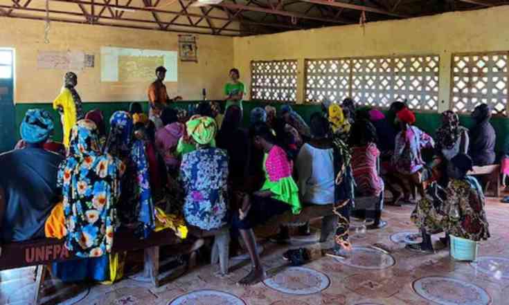 Jon, an agriculture volunteer in The Gambia, and Abdoulie (his counterpart) providing a workshop on the benefits of orange-fleshed sweet potatoes to women of the village.