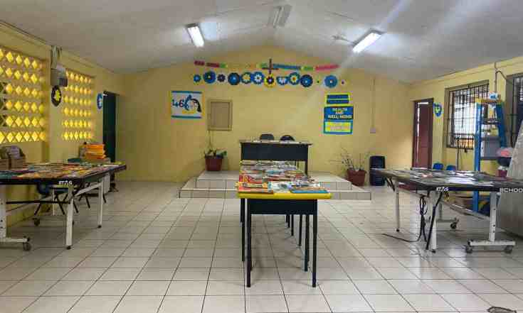 School rolling library with books on mobile tables set up by volunteer in St. Lucia education program
