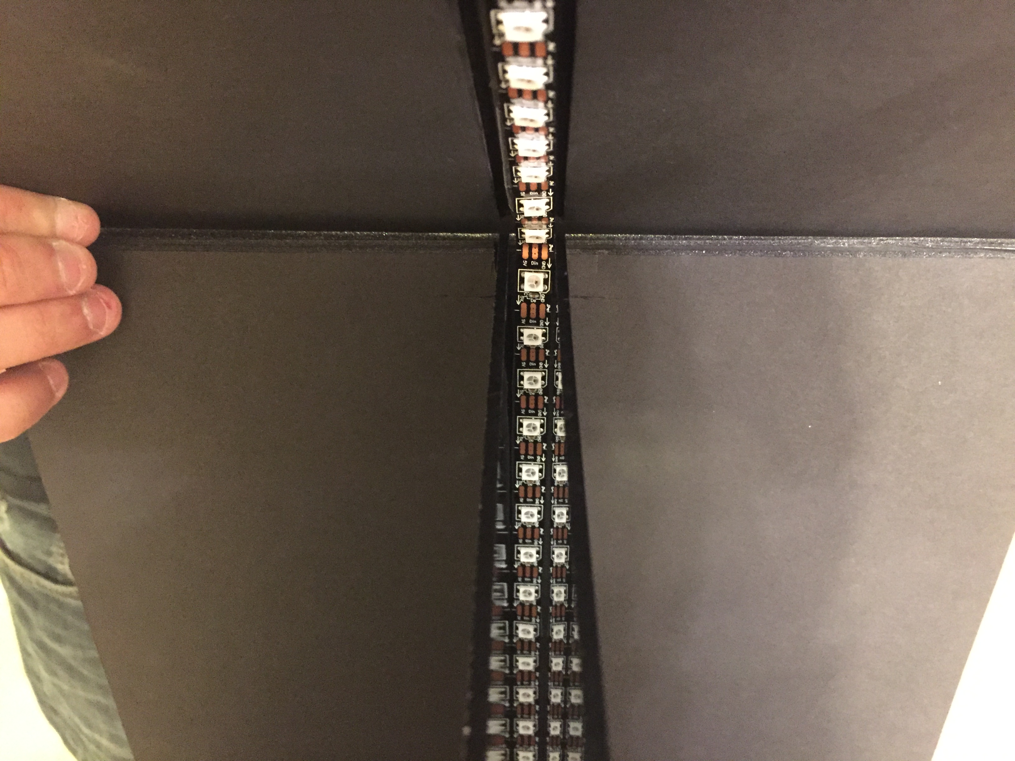 the installation of the lights and mirrors in a foam core mock up