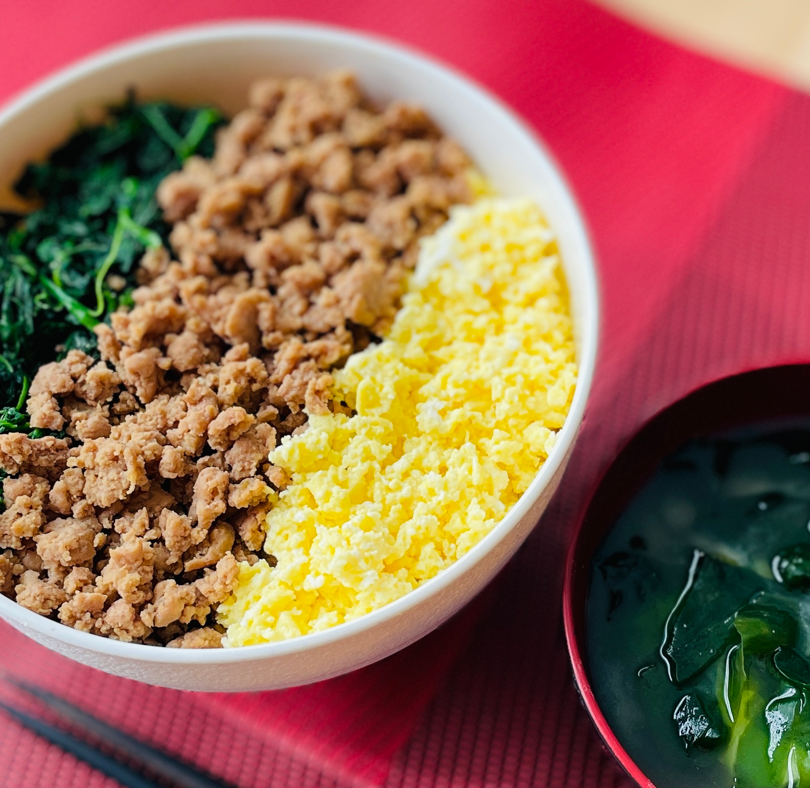 Ground turkey soboro donburi with scrambled eggs and spinach over steamed rice