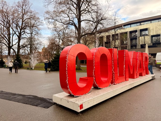 Giant red Colmar letters wrapped in Christmas lights