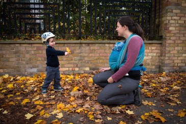 Warm Glow Photo I 197 Young boy playing in autumn leaves with mother on location family lifestyle shoot. Photographed by Anna Hindocha/Warm Glow Photo