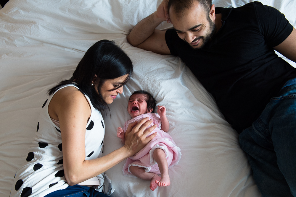 Warm Glow Photo P-139 Family lit by ambient light on bed.