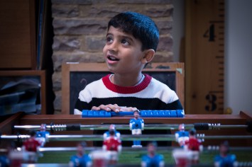 WGP L-344 Boy playing table football lit my ambient light. Photographed by Anna Hindocha/Warm Glow Photo