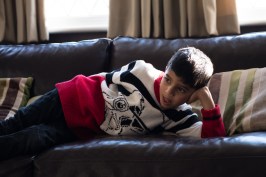 WGP L-357 Boy on a sofa lit my ambient light. Photographed by Anna Hindocha/Warm Glow Photo