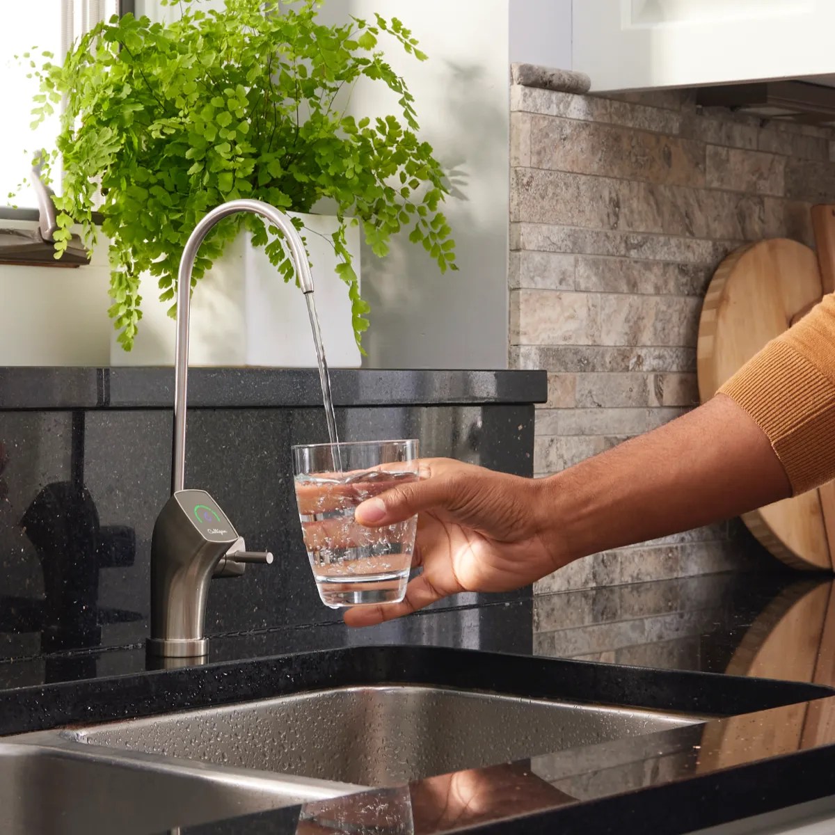 Water treatment specialist inspecting multi-stage home filtration setup
