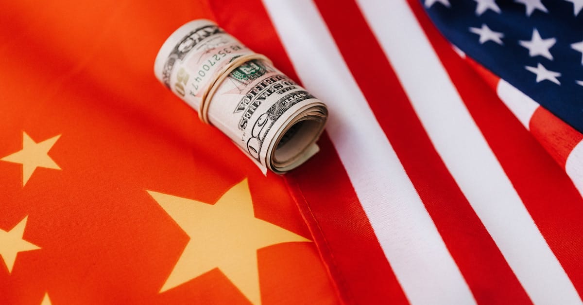Close-up of a USA and China flag with a financial graph, symbolizing trade tensions and tariffs.
