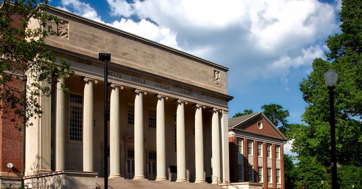 MIT campus building with clear blue sky, symbolizing university funding debate.