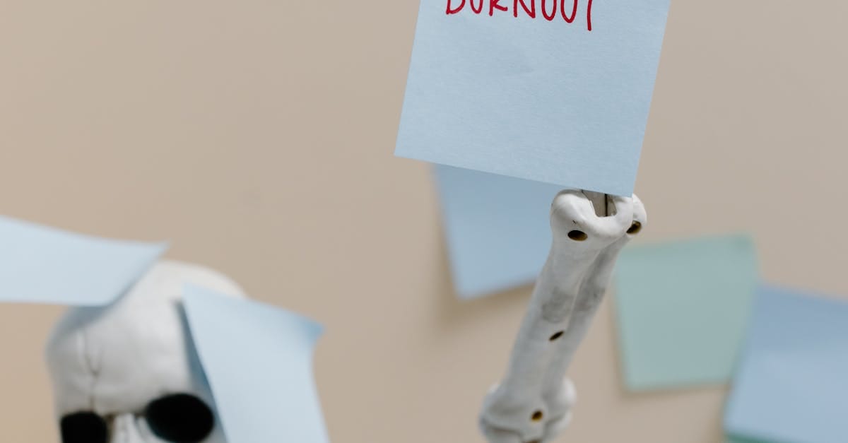Portrait of an elderly man with gray hair and glasses, wearing a dark suit and tie, looking directly at the camera.