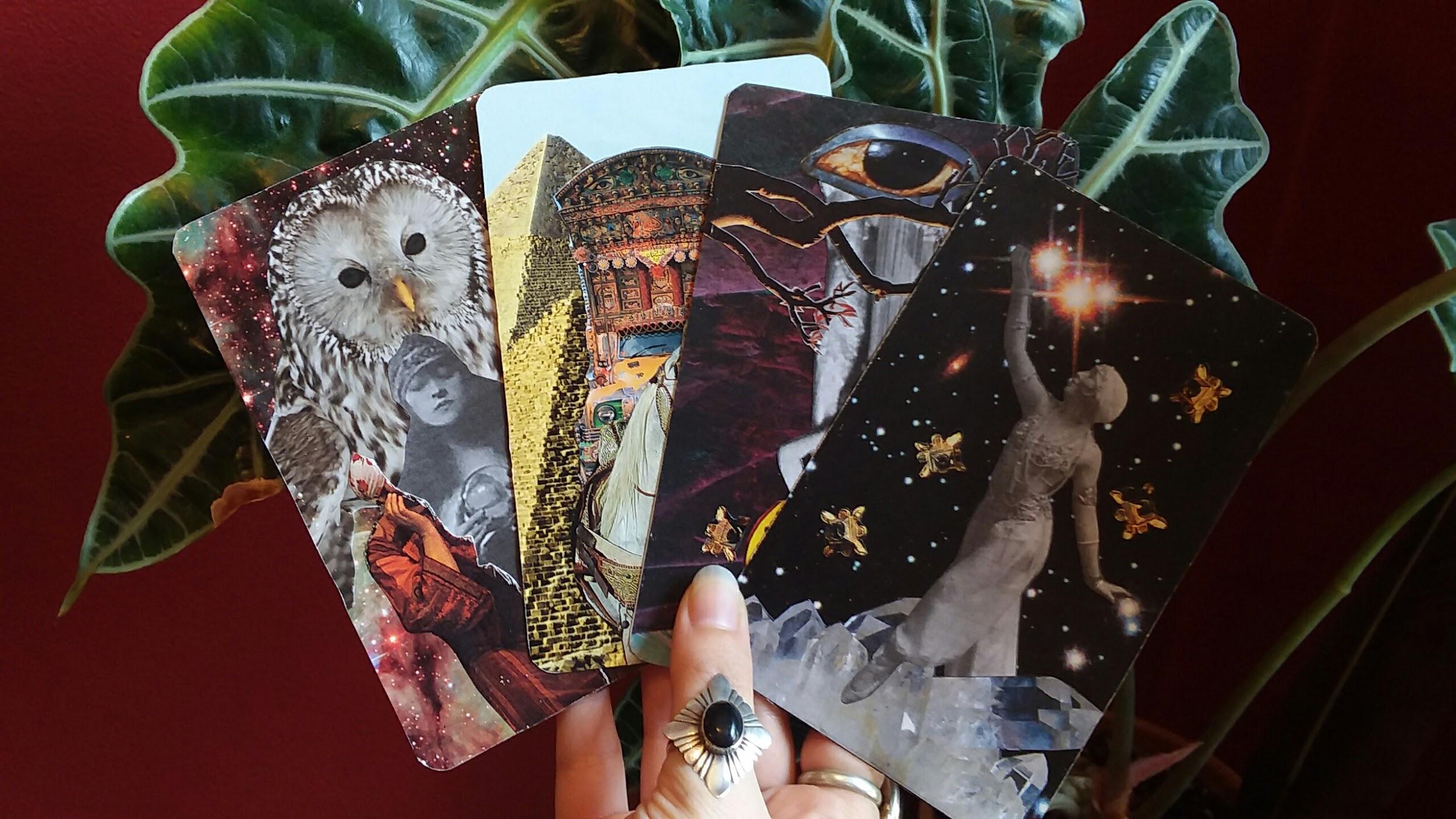 Hand holding handmade tarot cards with thumb ring