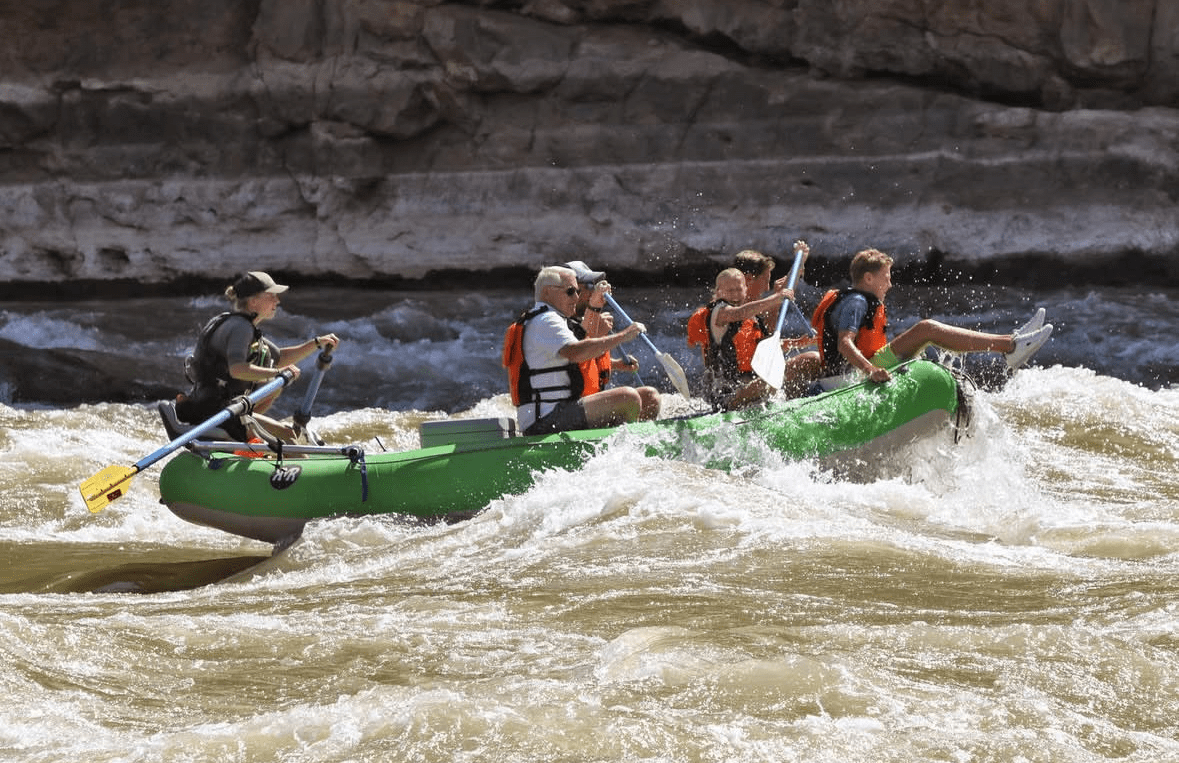 Guide with guests on the river in class 2 rapids