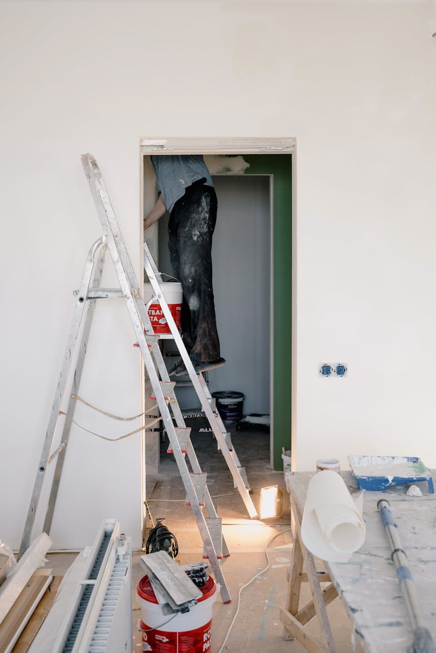 crop man doing renovation in room