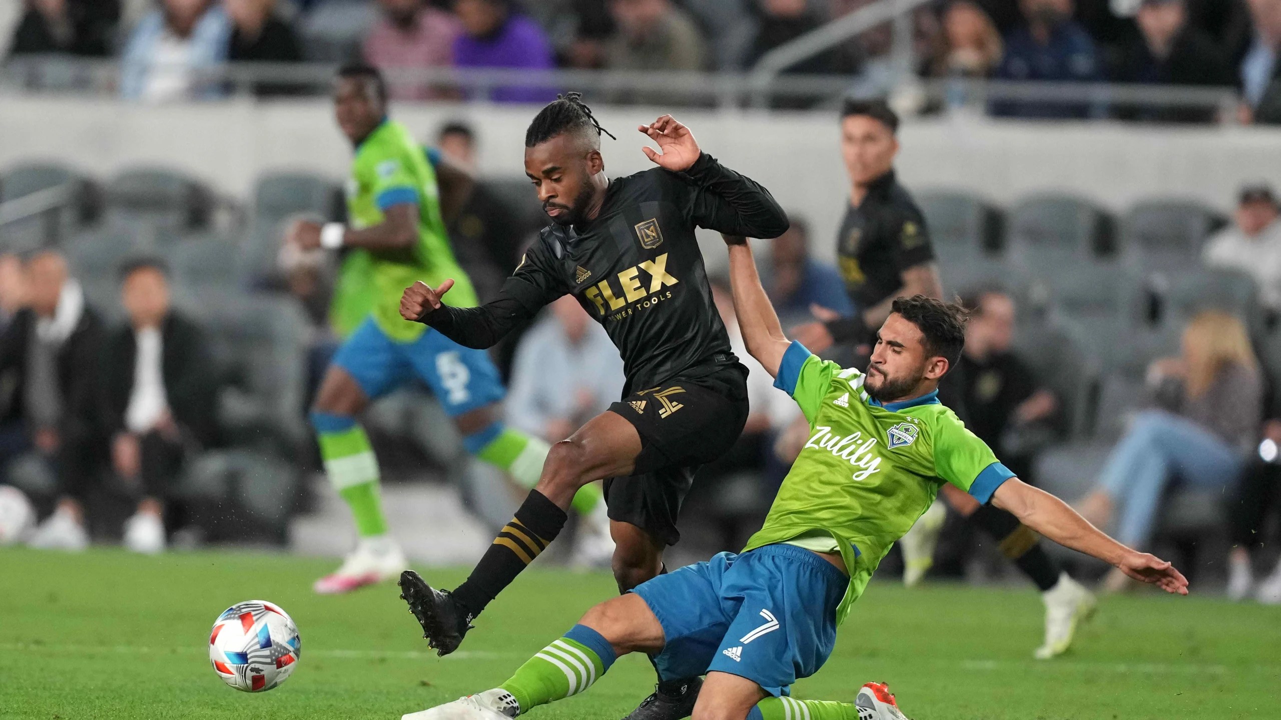 Cristian Roldan tackles the ball from the feet of an LAFC player