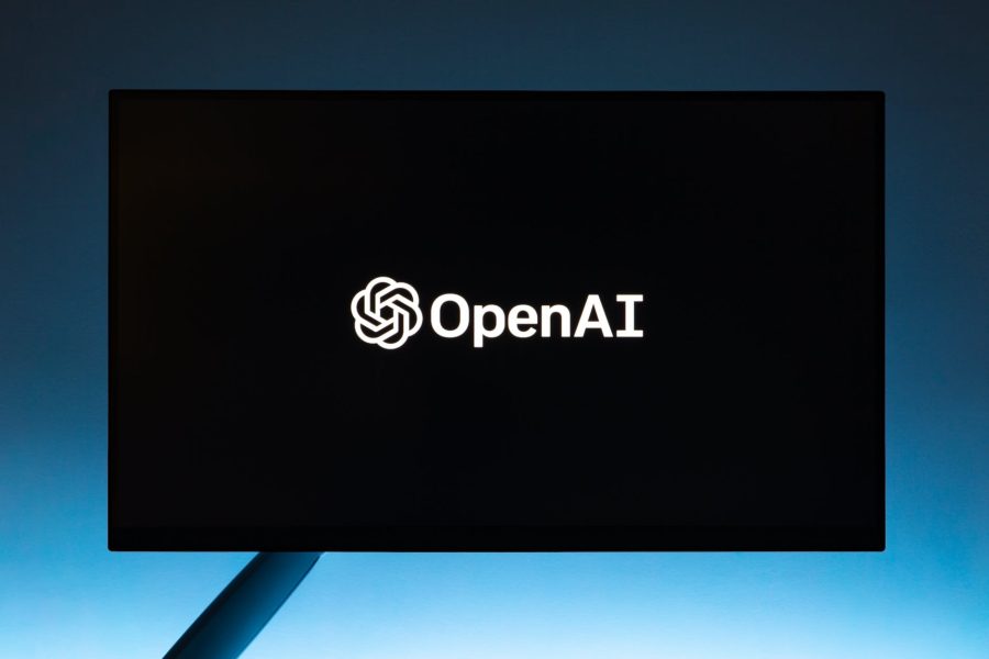 monitor screen with openai logo on black background: Does ChatGPT API Cost Money & How Much?