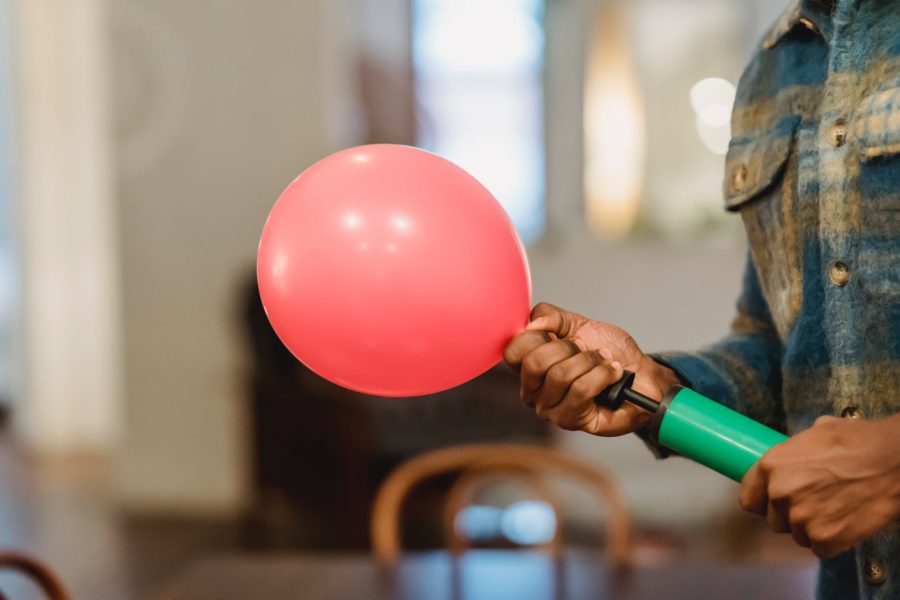 black man inflating balloon with pump: Free Text Inflator - Best Online Tool