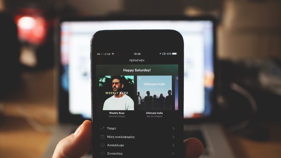 1. Find Opportunities in Online Music Platforms - pic: person using spotify on smartphone