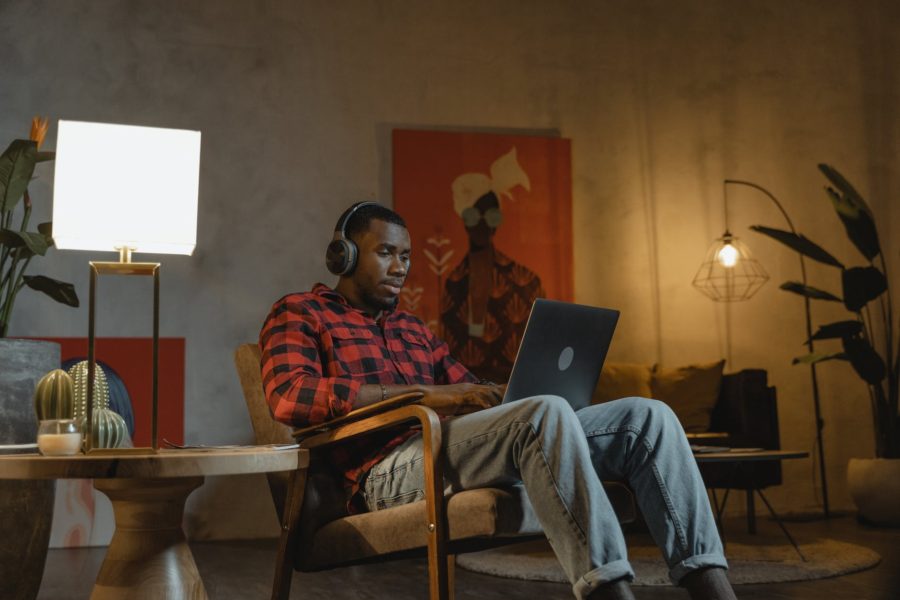 Remote Work Niches - pic: man sitting on an armchair while using his laptop