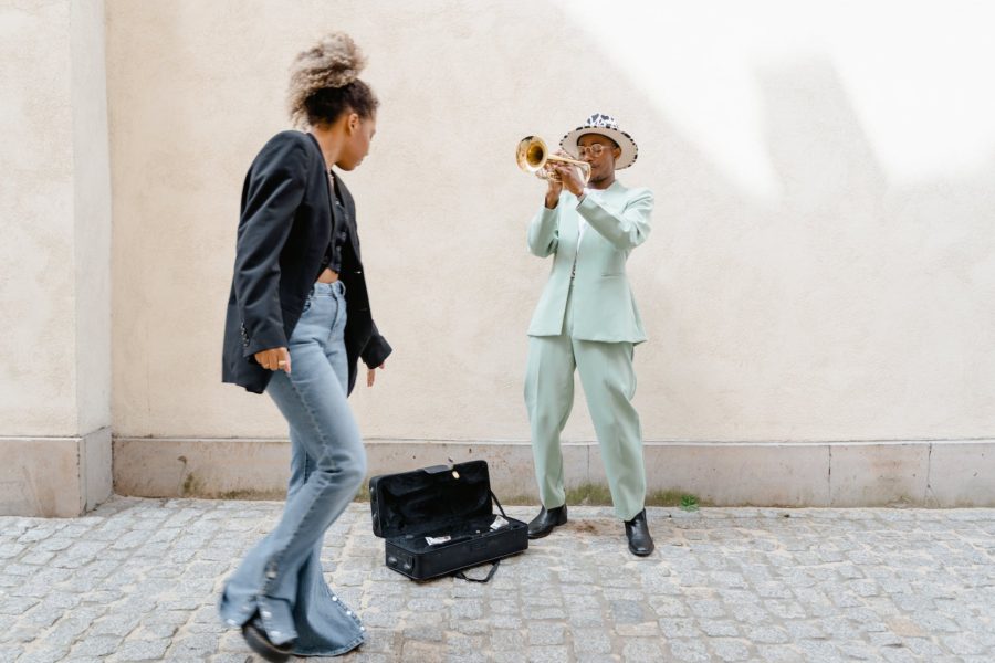 3. Monetize Your Online Presence - pic: woman giving coins to the man playing trumpet