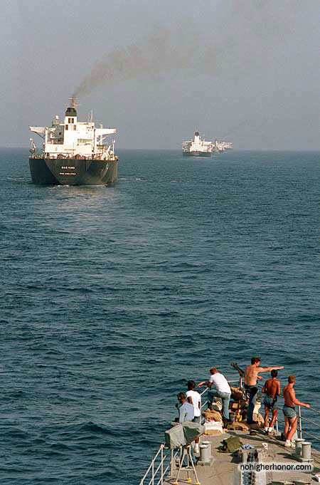 Crew members stand watch on the bow of the U.S. Navy guided missile destroyer USS <i>Kidd</i> (DDG 993) as reflagged Kuwaiti tankers move through Persian Gulf waters on 22 September 1987 during Operation Earnest Will.
