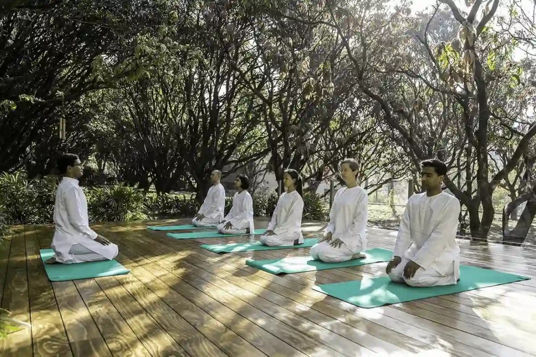 Person practicing yoga indoors, seated in a meditation pose
