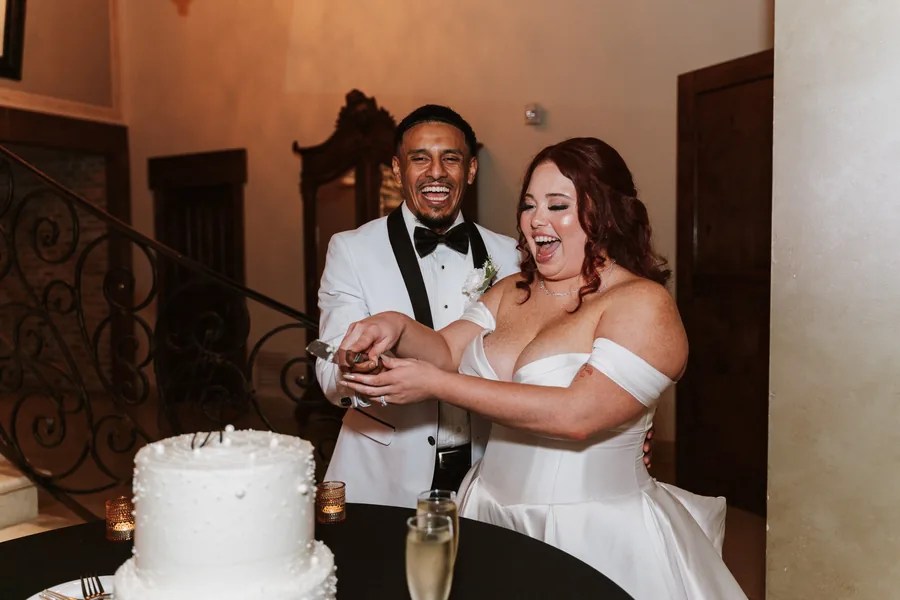 Bride and groom cutting the wedding cake at The Bell Tower on 34th, Houston, TX