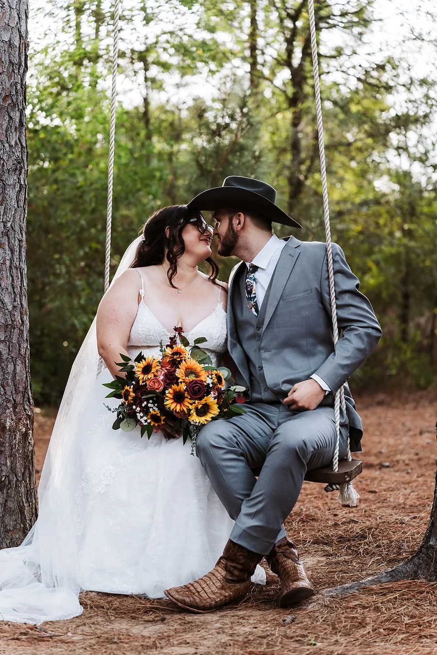 Wedding ceremony kiss under floral arch at Fountain View Farms, Splendora, TX
