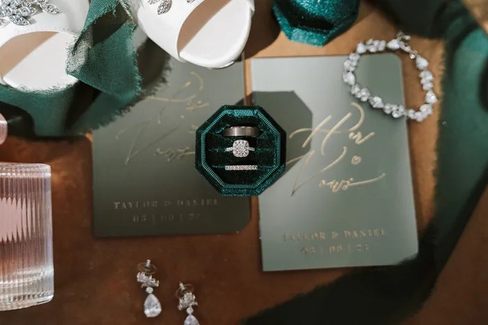 Wedding invitation suite with rings and jewelry at Iron Manor by Walters Wedding Estates, Texas