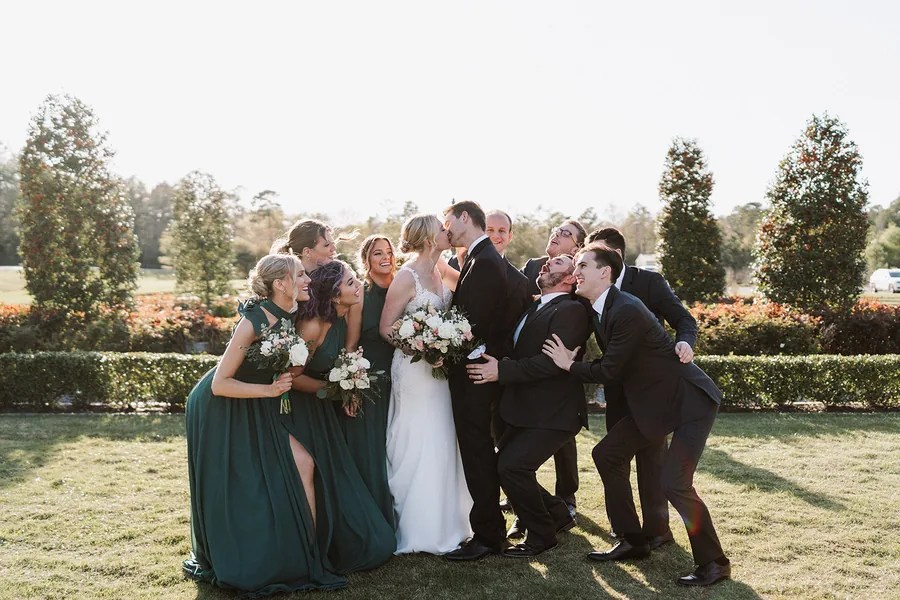 Bridal party laughing together outdoors at Iron Manor by Walters Wedding Estates, Texas