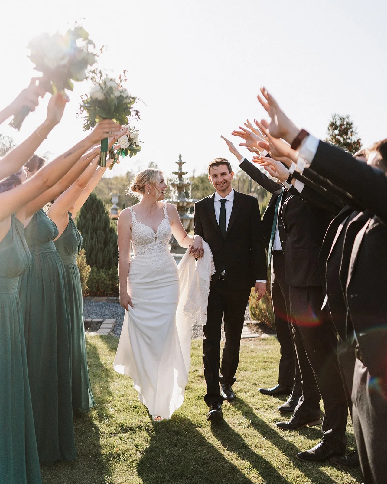 Bridal party celebrating with the couple on the lawn at Iron Manor by Walters Wedding Estates, Texas