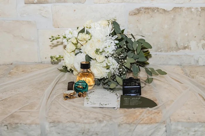 Wedding invitation suite flat lay with rings and details at The Oaks at Oak Plantation, Texas