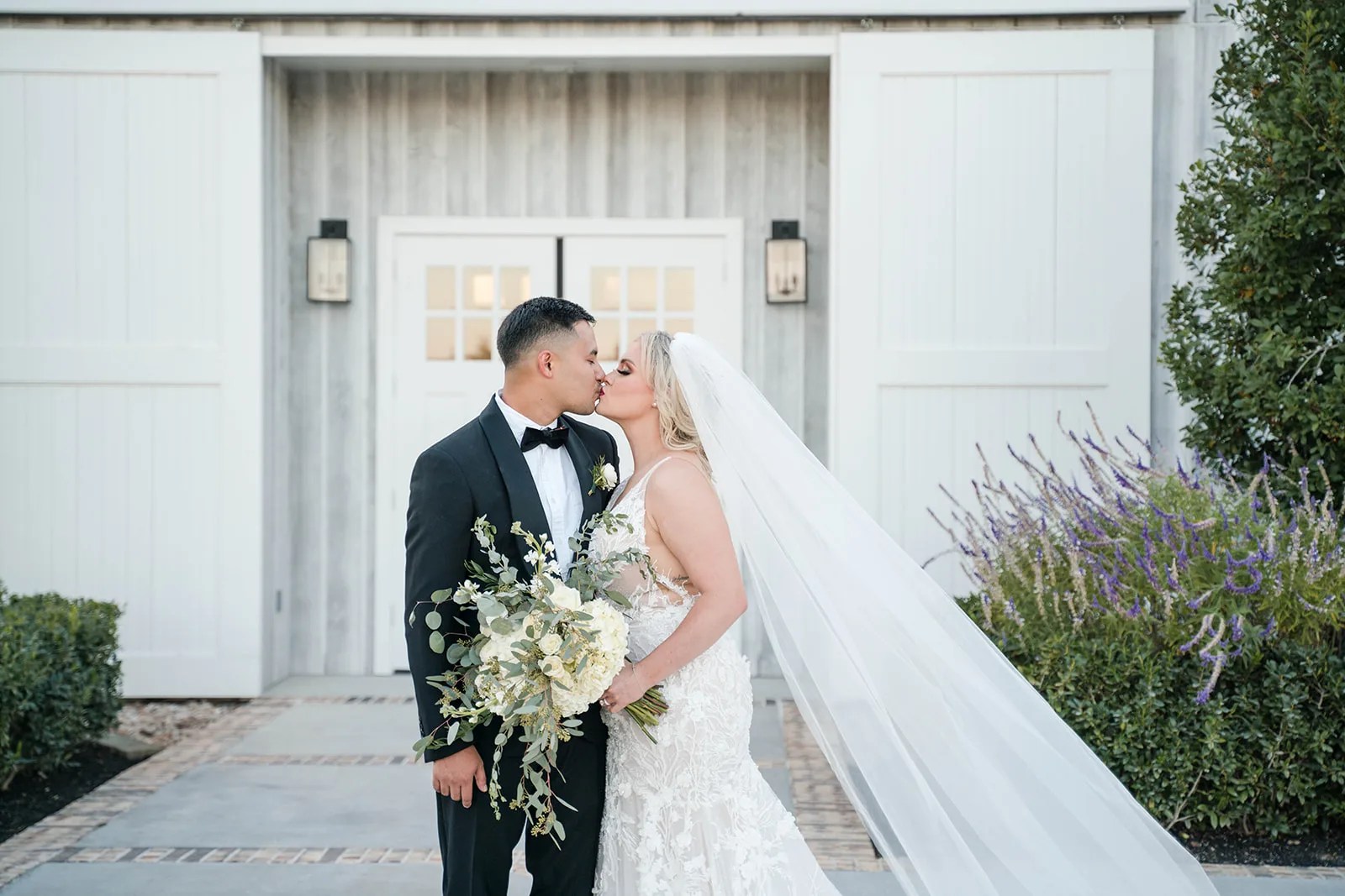 Couple at the white barn doors at Arrowhead Hill, Montgomery, TX