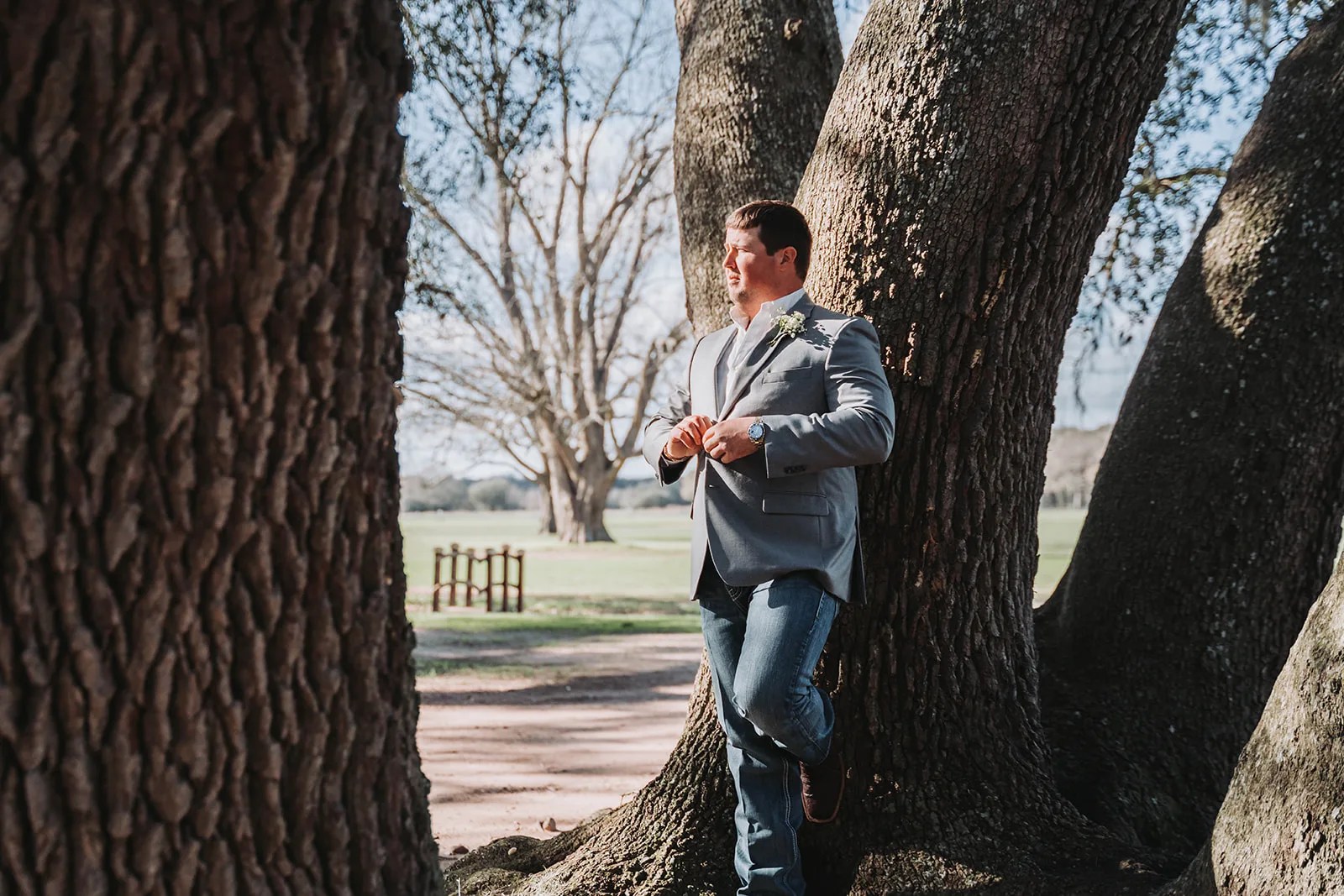 Bride and groom under the live oaks at Beneath The Oaks in Midfield, TX