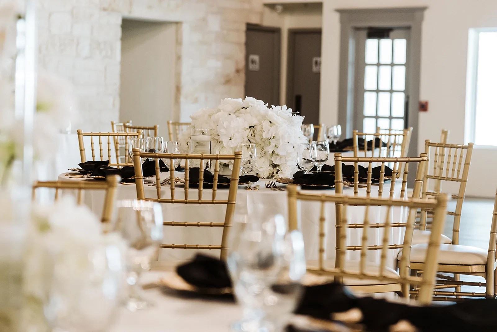 The Grand Ballroom set with gold chairs at Briscoe Manor, Richmond, TX