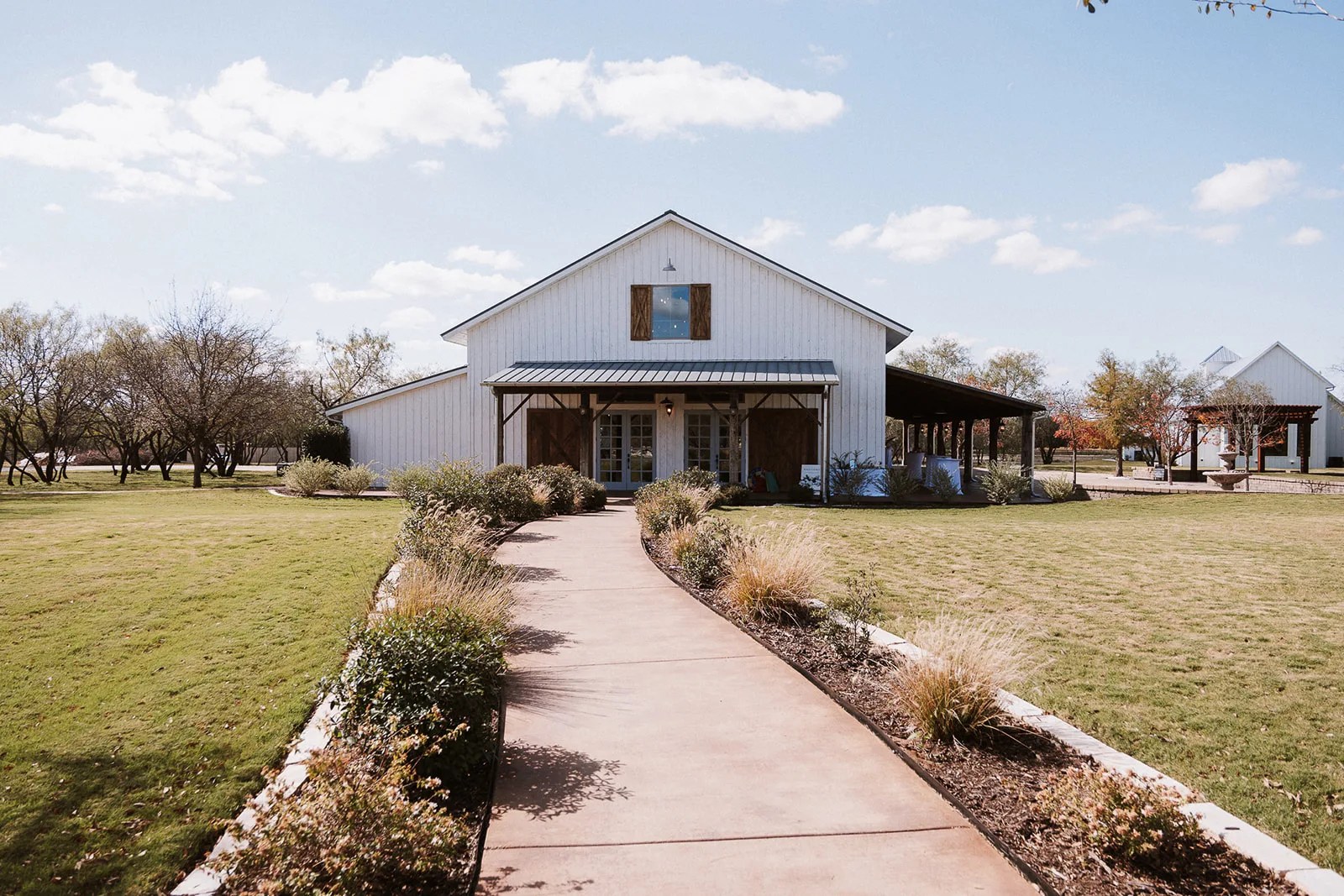 White venue building at Deerfield Estates Venue in Waco, Texas at Deerfield Estates Venue, Waco, TX