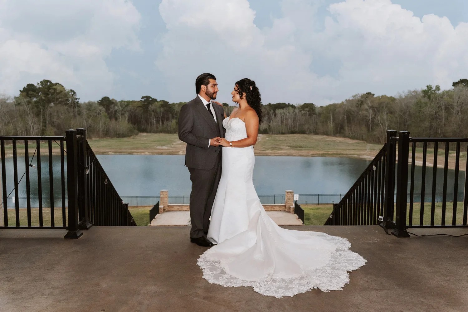 Bride on the deck overlooking the lake at D'Gala Ranch, Crosby, TX