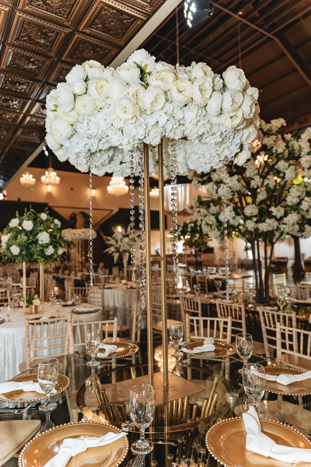 Reception tables and floral centerpieces at D'Gala Ranch, Crosby, TX