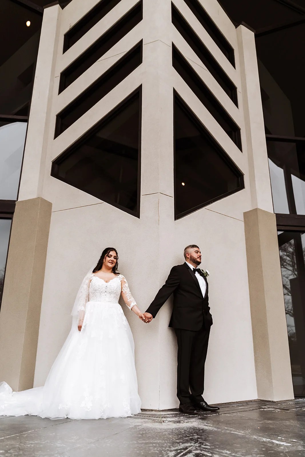 Bride and groom under the steel beam canopy at Jennings Trace, Montgomery, TX
