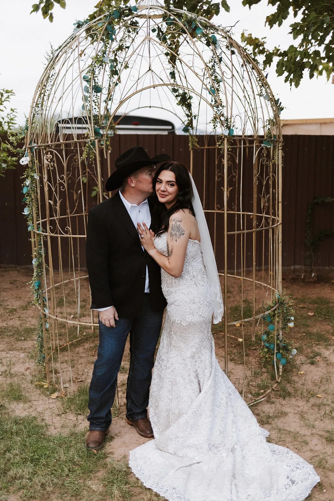 Bride and groom at the arbor at Kelly's Cottage Tolleson at Kelly's Cottage, Tolleson, AZ