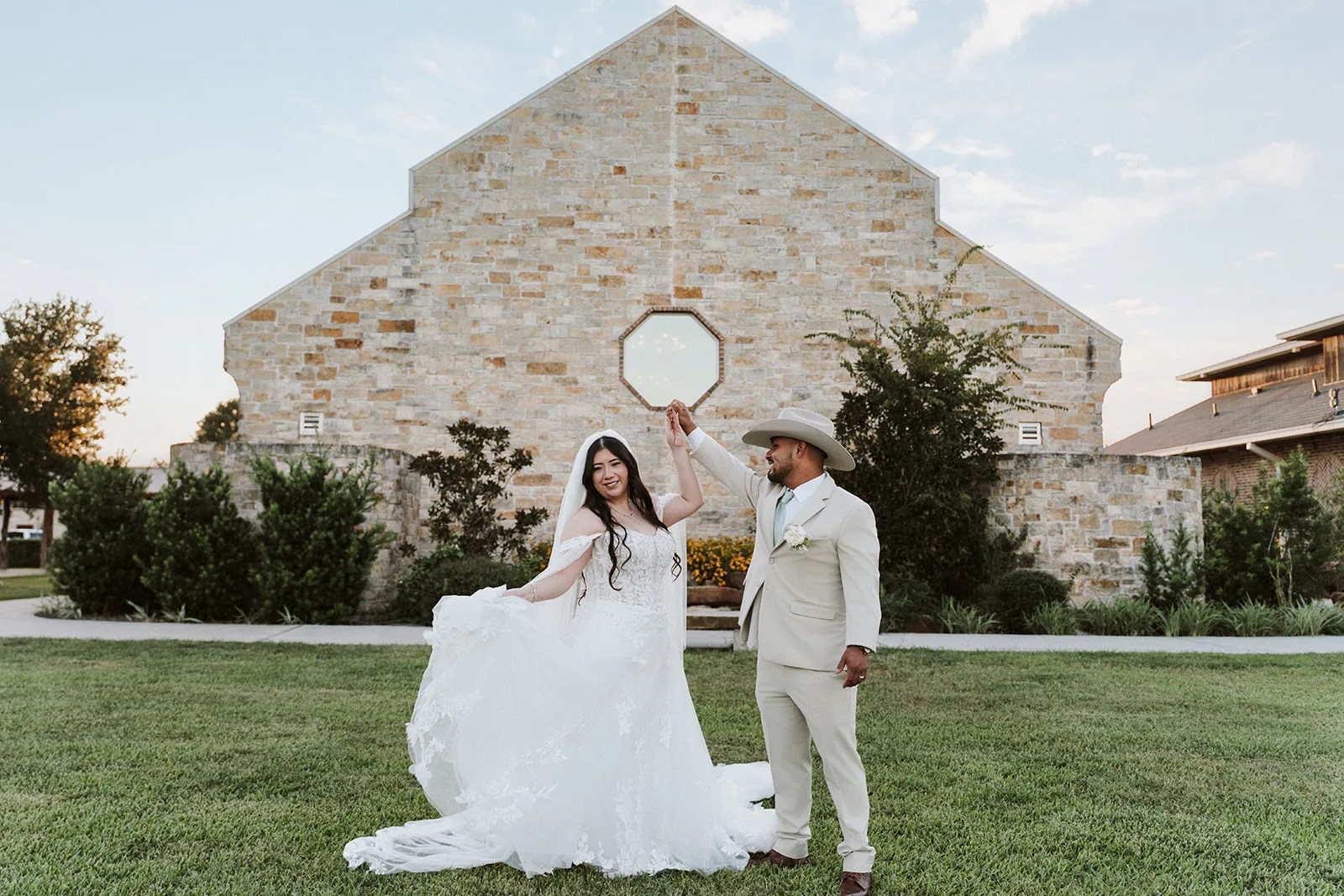 Couple in front of the ivory stone chapel at Lindsay Lakes, Cypress, TX