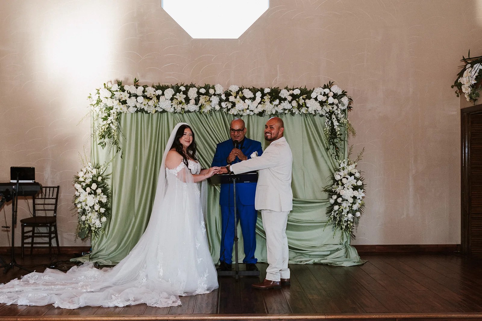 Vows at the greenery arch at Lindsay Lakes, Cypress, TX